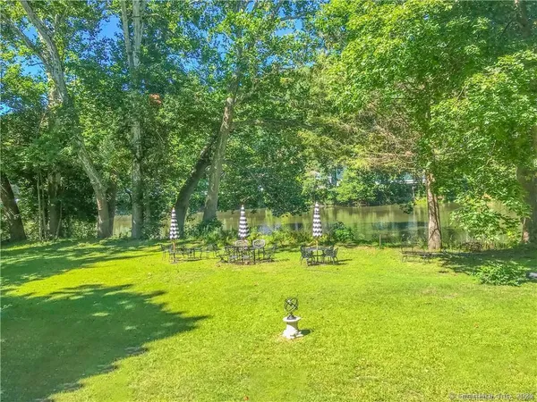 a view of a lake with a table and chairs