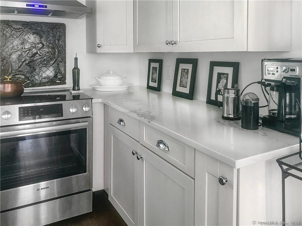 47 Johnson Road Kent, CT 06757 - Photo 4 of 40 a kitchen with granite countertop white cabinets and stainless steel appliances
