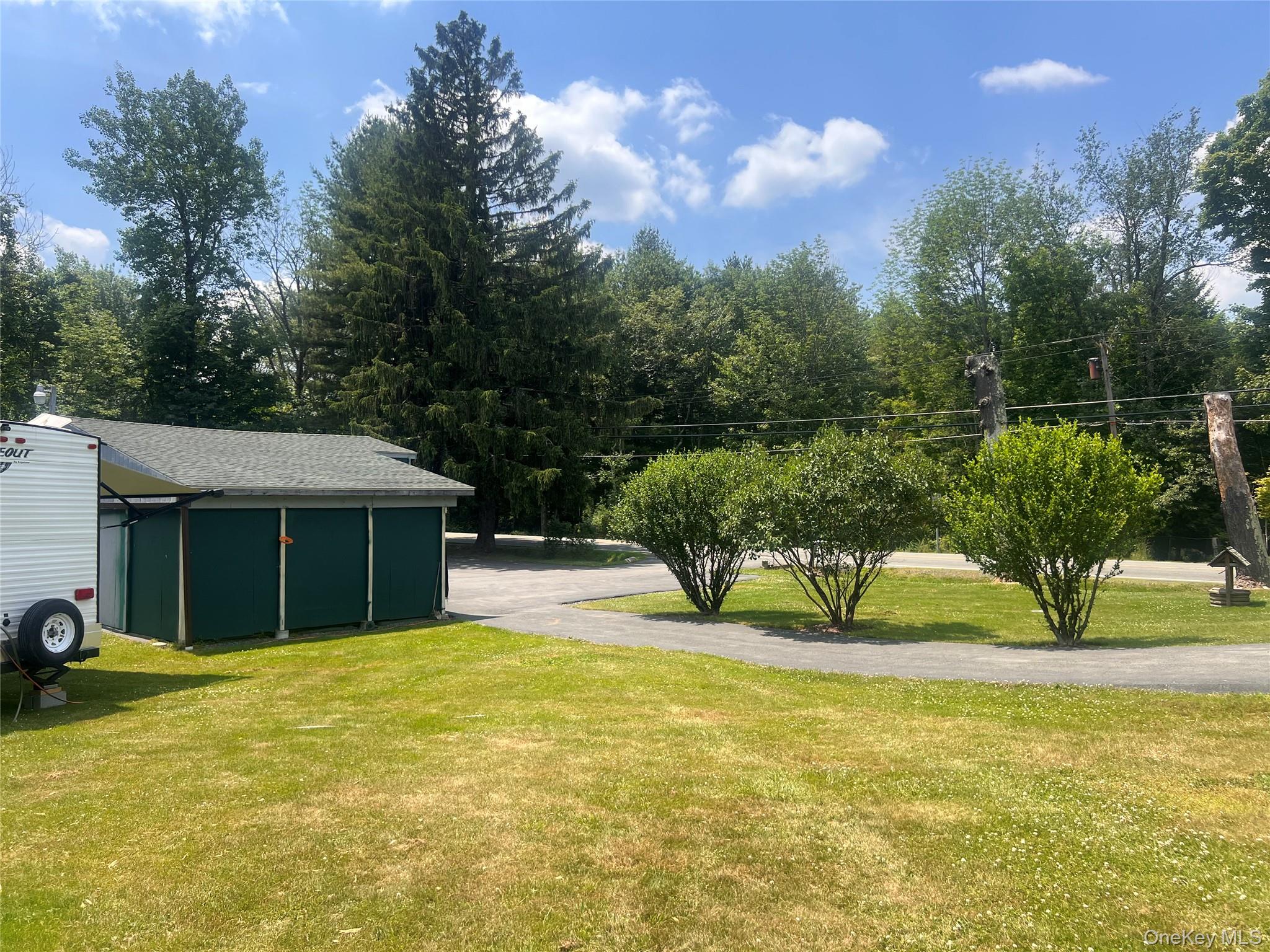 279 Cold Spring Road Monticello, NY 12701 - Photo 22 of 32 View of grassy yard featuring an outdoor structure