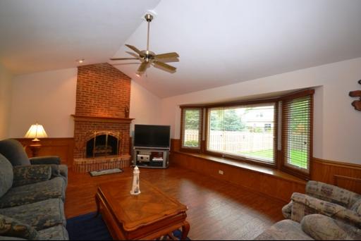 1860 Lisson Road Naperville, IL 60565 - Photo 6 of 16 a living room with furniture a fireplace and a flat screen tv
