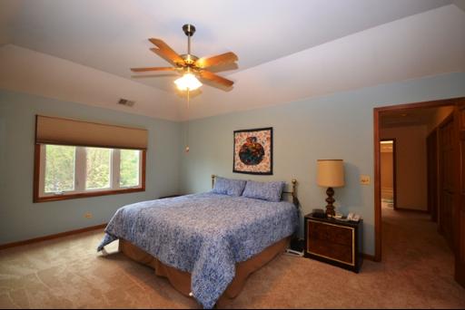 1860 Lisson Road Naperville, IL 60565 - Photo 10 of 16 a bedroom with a bed and a chandelier