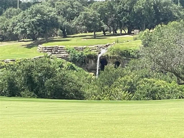 a view of a field with an ocean view