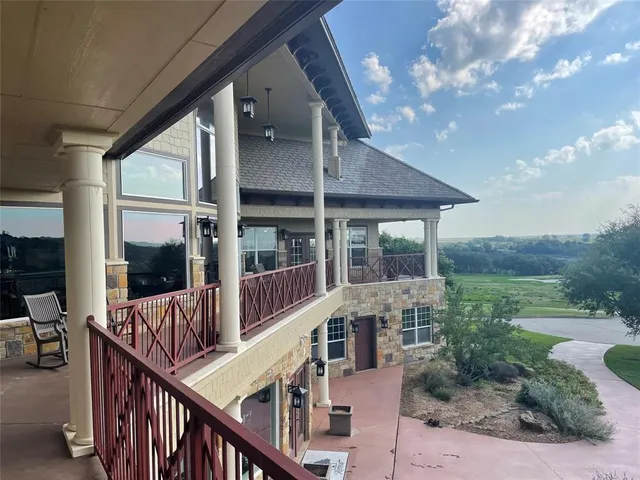 a view of a house with backyard and porch
