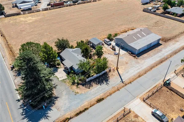 an aerial view of a house with a yard and lake view