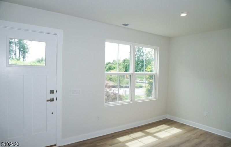 60 Coventry Road Hamburg, NJ 07419 - Photo 2 of 15 a view of empty room with wooden floor and fan