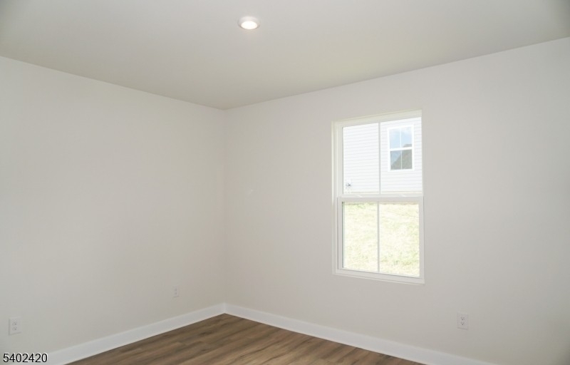 60 Coventry Road Hamburg, NJ 07419 - Photo 4 of 15 an empty room with wooden floor and windows