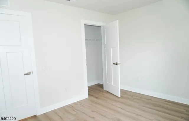 a view of a room with wooden floor