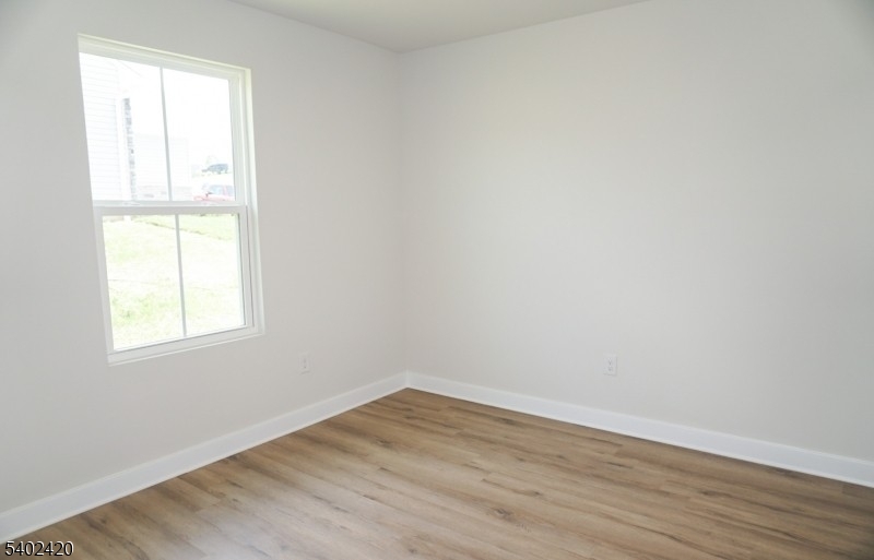60 Coventry Road Hamburg, NJ 07419 - Photo 6 of 15 an empty room with wooden floor and windows