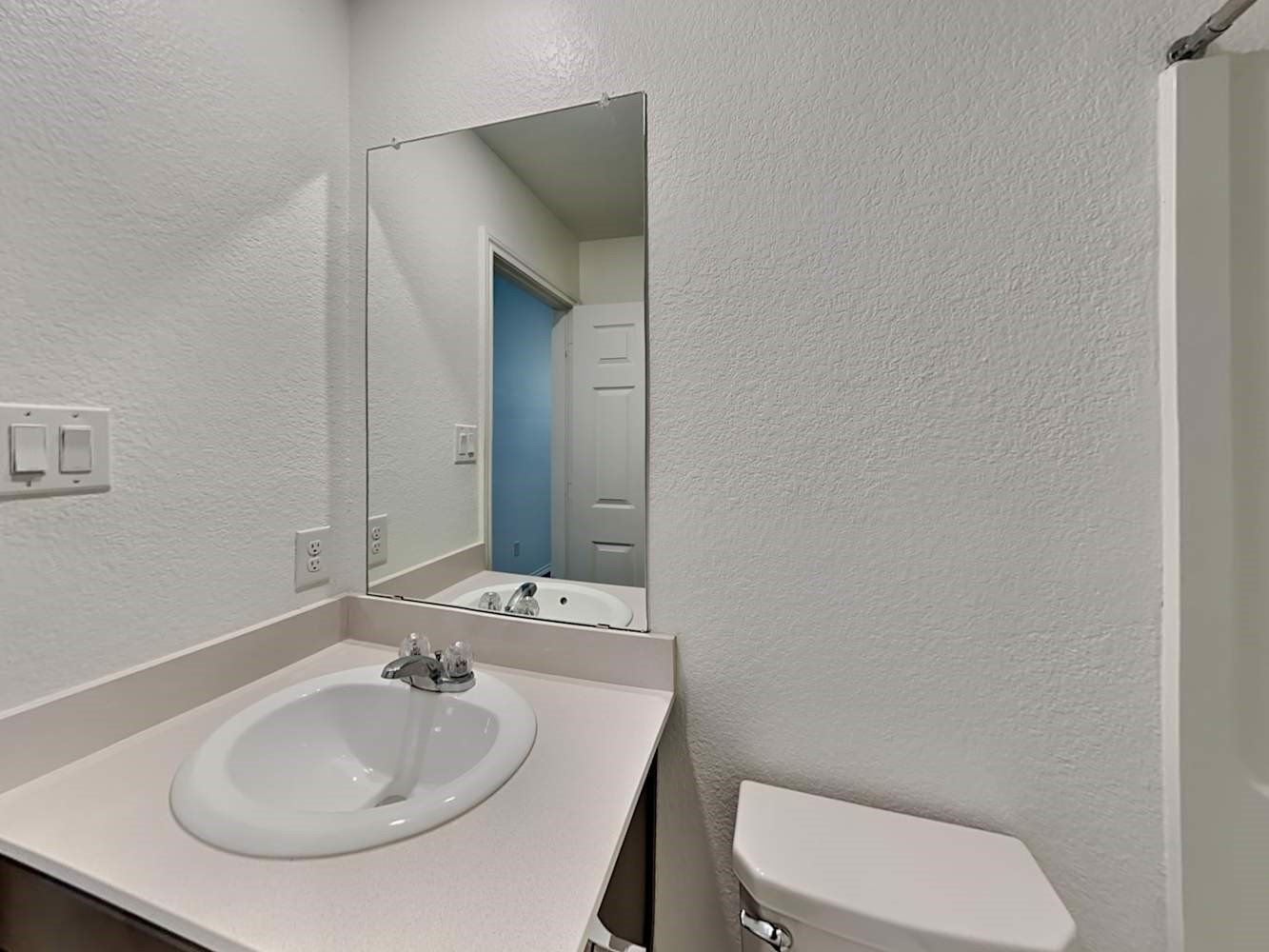18823 Orvieto Court New Caney, TX 77357 - Photo 14 of 15 a bathroom with a toilet sink and mirror