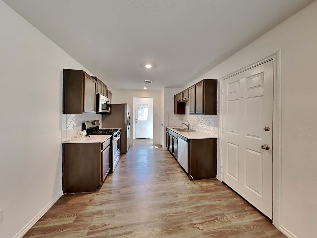 18823 Orvieto Court New Caney, TX 77357 - Photo 5 of 15 a large kitchen with a center island and stainless steel appliances