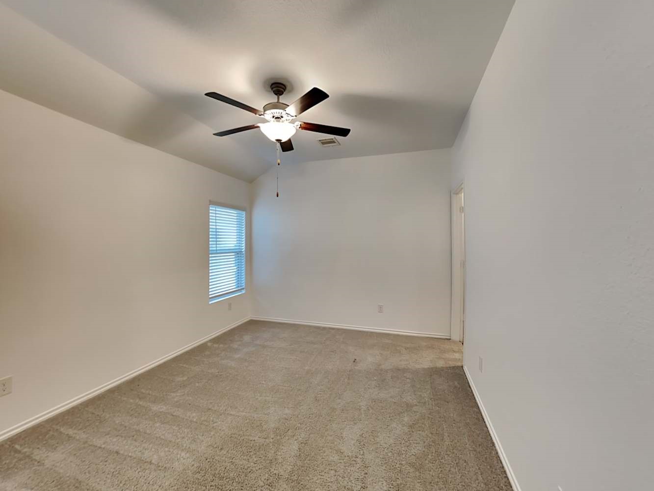 18823 Orvieto Court New Caney, TX 77357 - Photo 6 of 15 an empty room with windows and fan