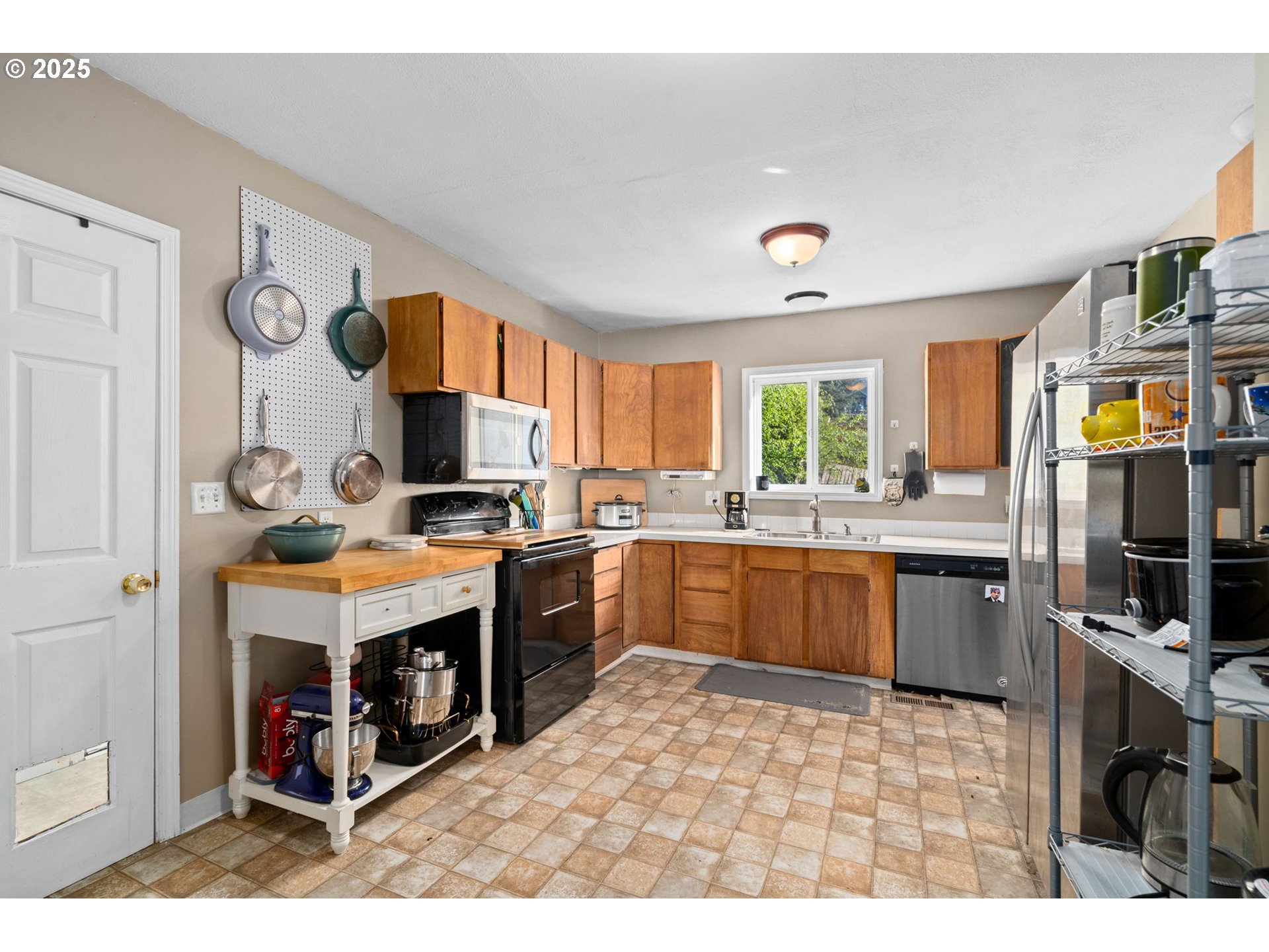 410 East D Street Rainier, OR 97048 - Photo 13 of 18 a kitchen with a refrigerator stove top oven a sink and dishwasher