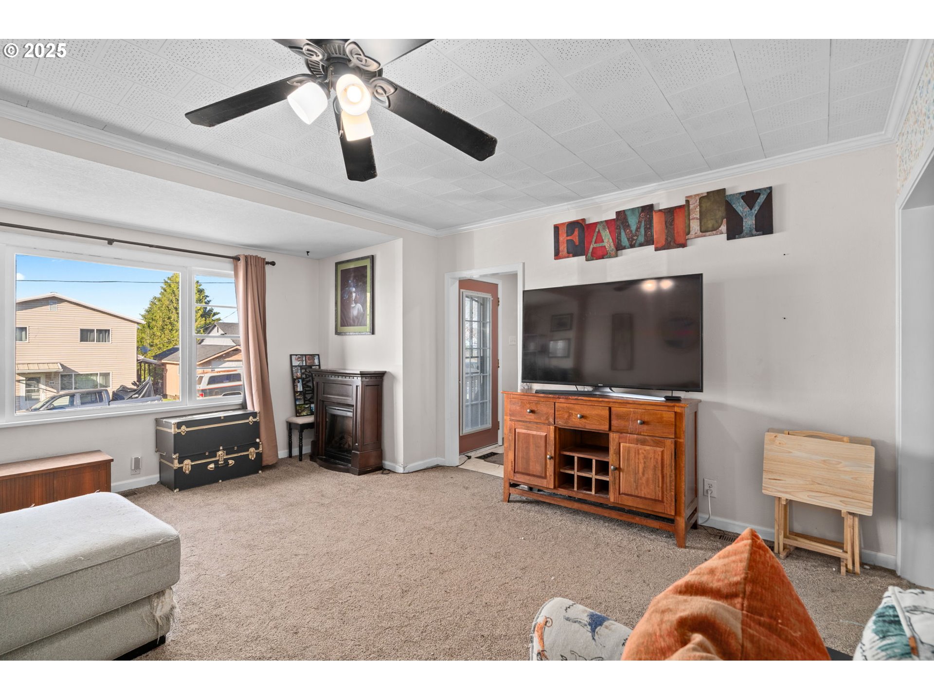 410 East D Street Rainier, OR 97048 - Photo 6 of 18 a living room with furniture and a flat screen tv