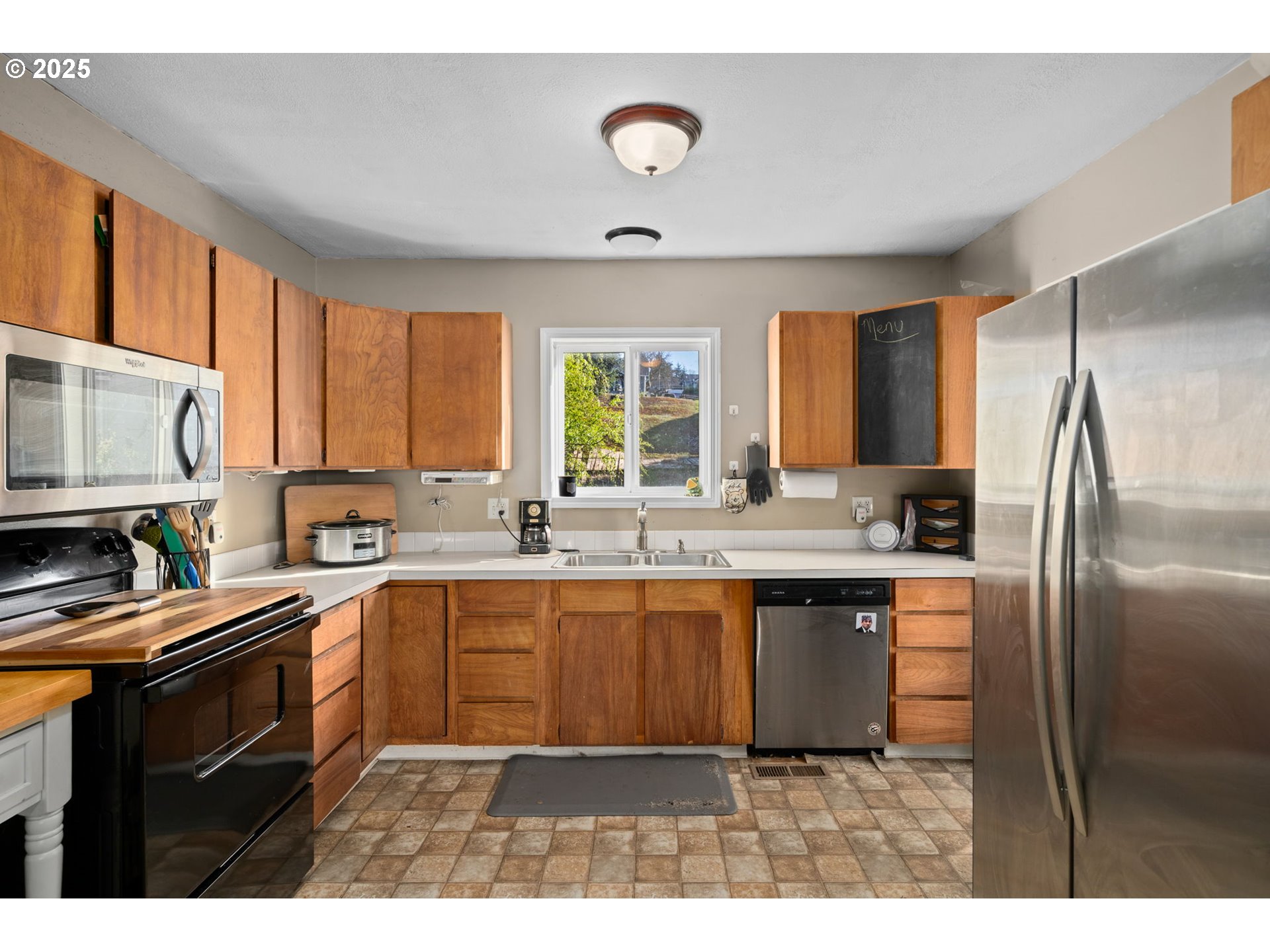 410 East D Street Rainier, OR 97048 - Photo 7 of 18 a kitchen with granite countertop a sink stainless steel appliances and cabinets