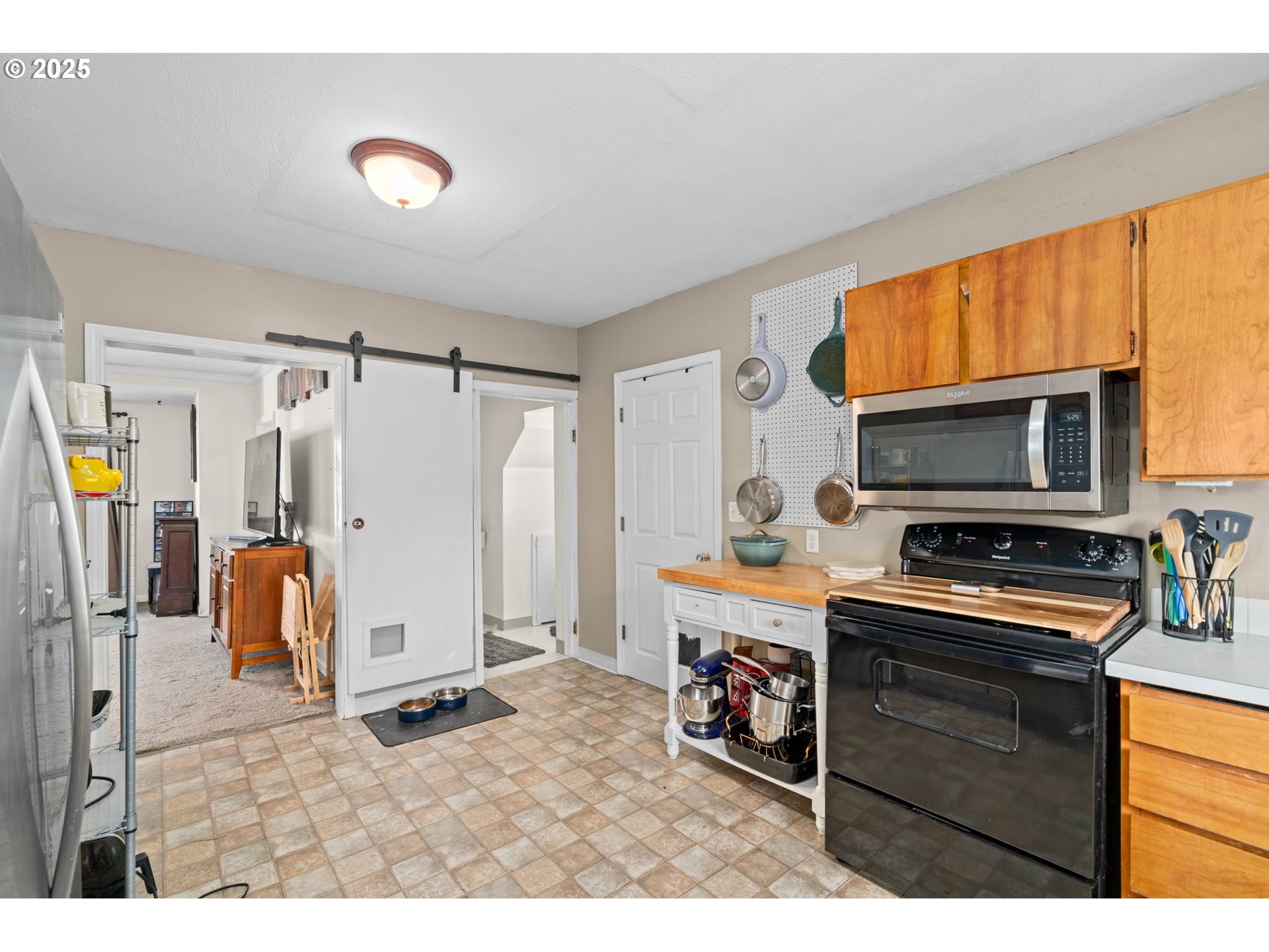 410 East D Street Rainier, OR 97048 - Photo 8 of 18 a kitchen with stainless steel appliances granite countertop a refrigerator a stove and a sink with wooden floor
