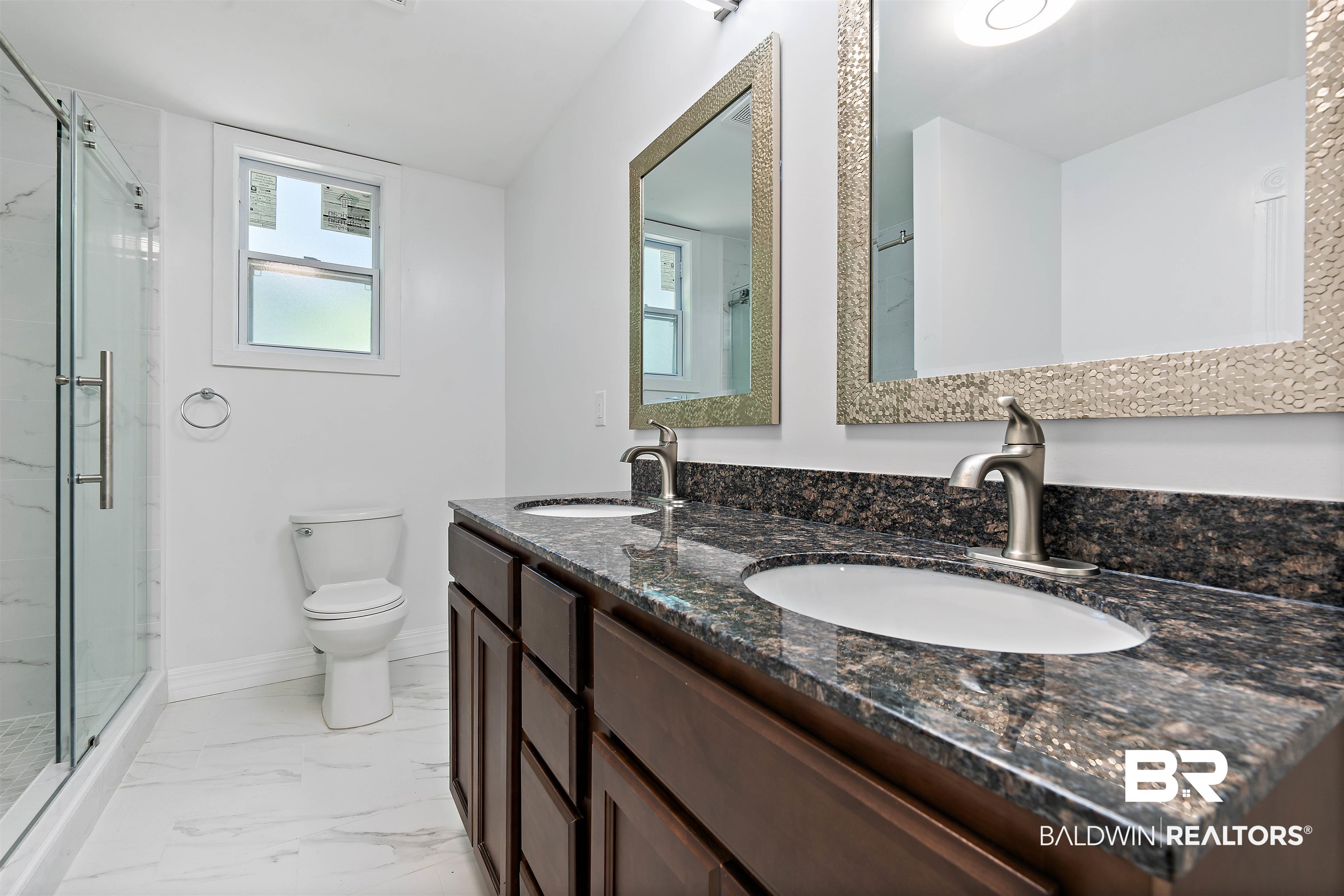 407 East 2nd Street Bay Minette, AL 36507 - Photo 30 of 40 Bathroom featuring a stall shower, double vanity, and light marble finish floors