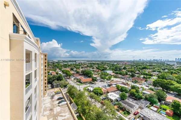 a view of a dining room with furniture large windows and wooden floor