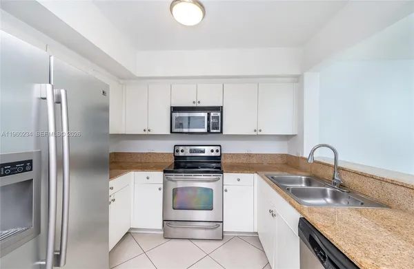 a kitchen with a sink stove and refrigerator