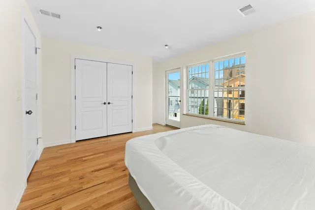 a view of a balcony with wooden floor and iron fence