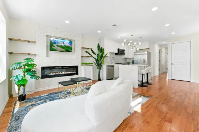 a bedroom with a bed window and wooden floor