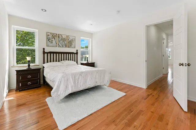a bathroom with a granite countertop bathtub sink vanity mirror and toilet
