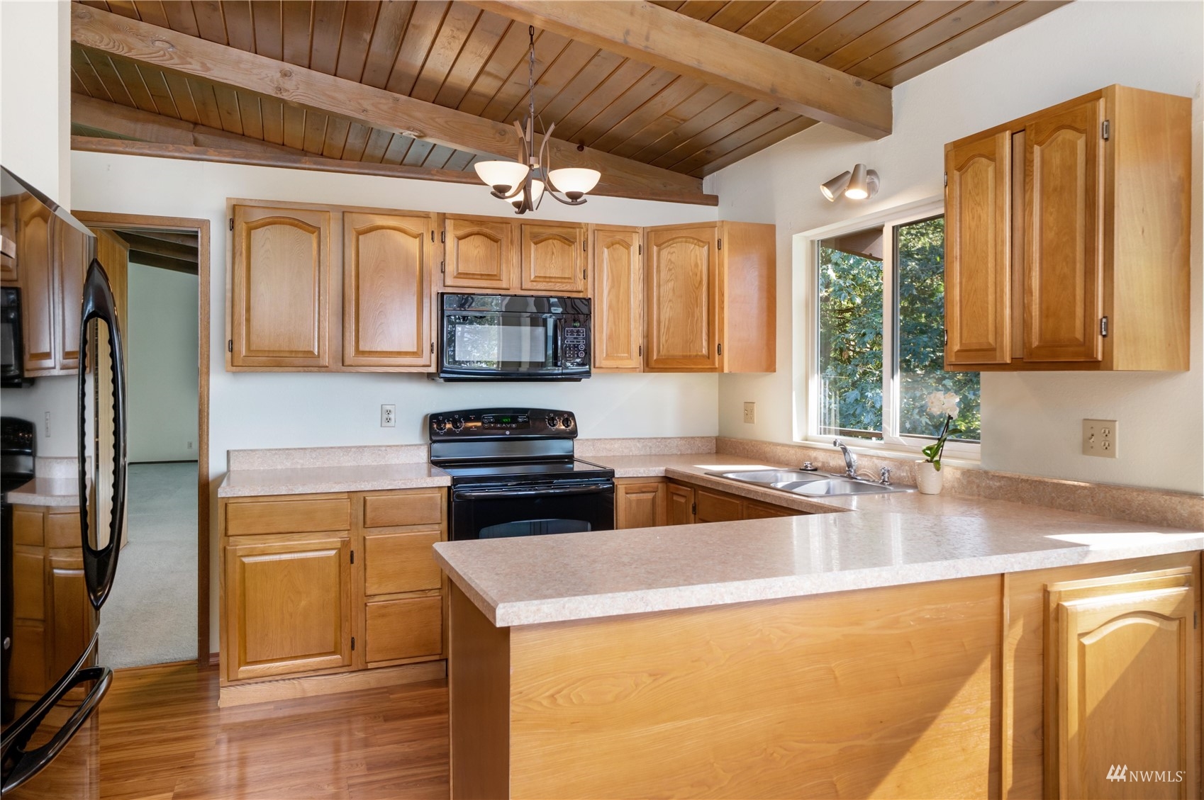 30807 26th Avenue Southwest Federal Way, WA 98023 - Photo 19 of 40 a kitchen with stainless steel appliances granite countertop a sink a stove and a microwave