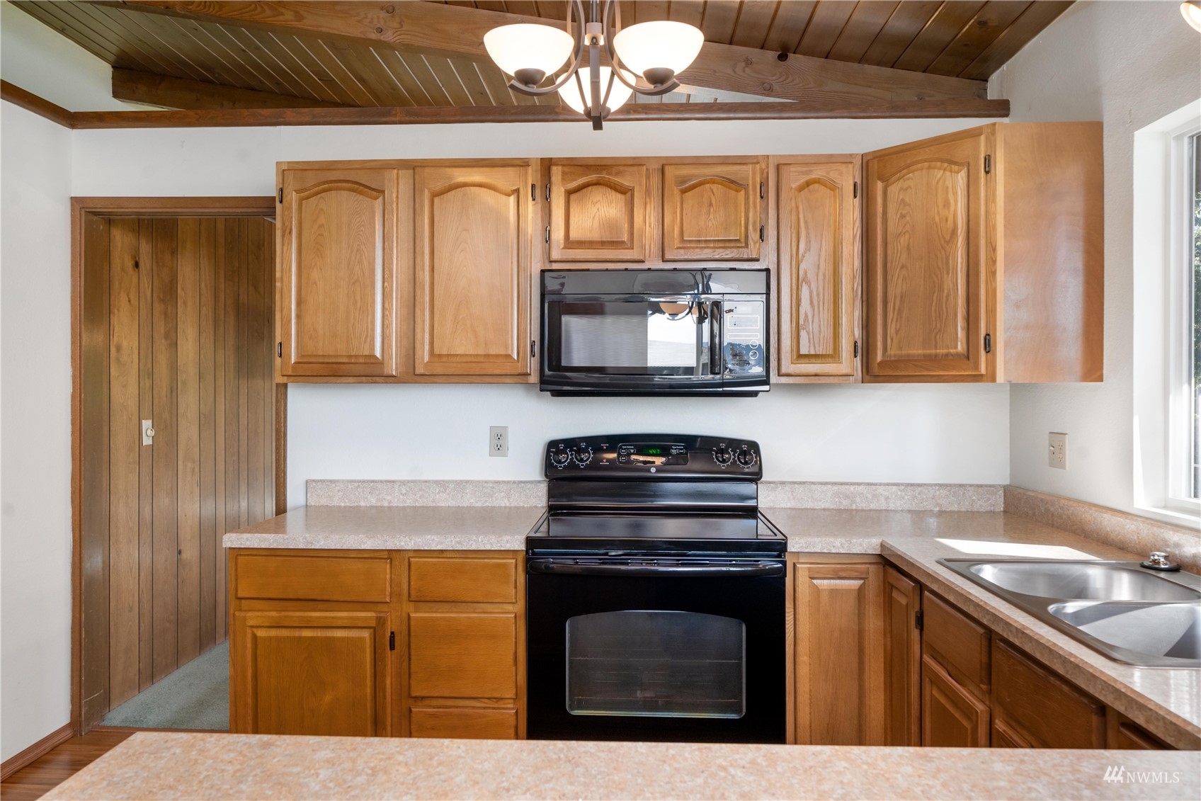 30807 26th Avenue Southwest Federal Way, WA 98023 - Photo 20 of 40 a kitchen with stainless steel appliances granite countertop a stove a sink and a microwave