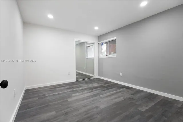 an empty room with wooden floor