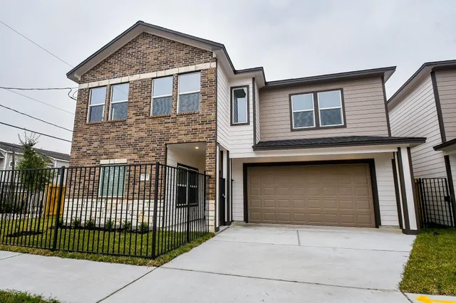 a front view of a house with garage