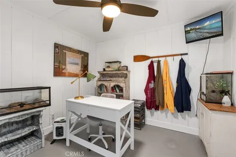 a view of a room with furniture and a flat screen tv