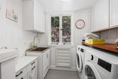 a kitchen with a sink cabinets and window
