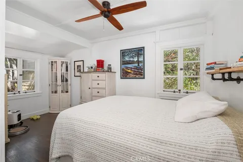 a bedroom with a bed dresser and a window