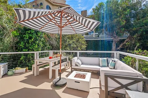 a view of a patio with a table chairs and a wooden deck