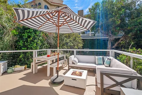 a view of a patio with a table chairs and a wooden deck