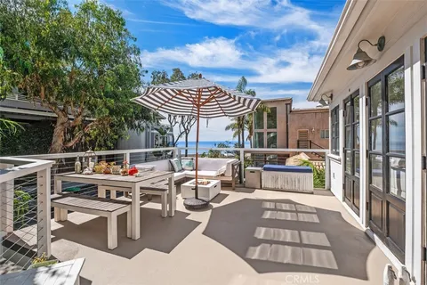 a view of a patio with a dining table and chairs with wooden floor