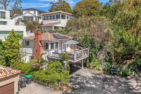 an aerial view of a house with a yard in front of it