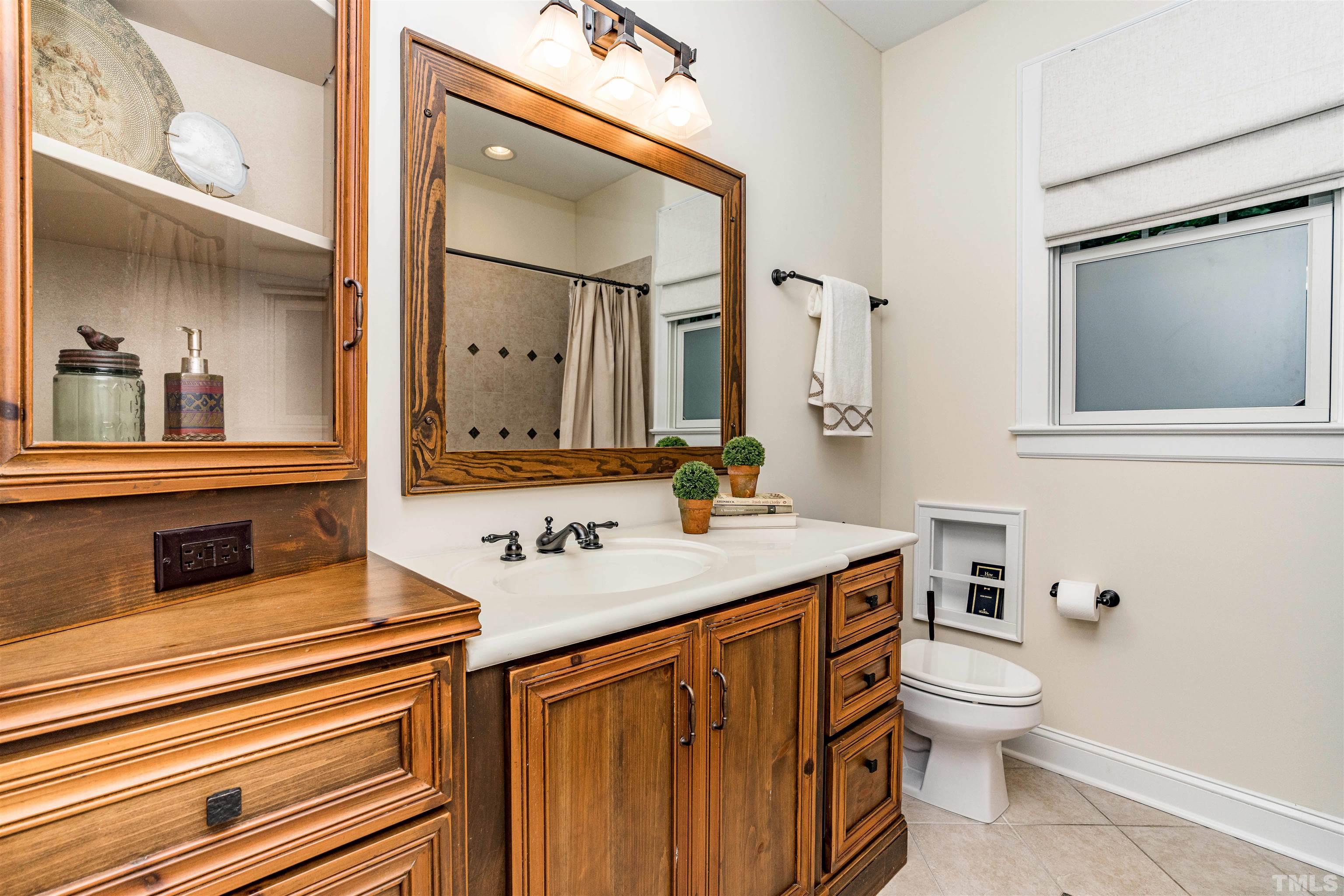 2706 Barmettler Street Raleigh, NC 27607 - Photo 24 of 43 a bathroom with a toilet sink and mirror