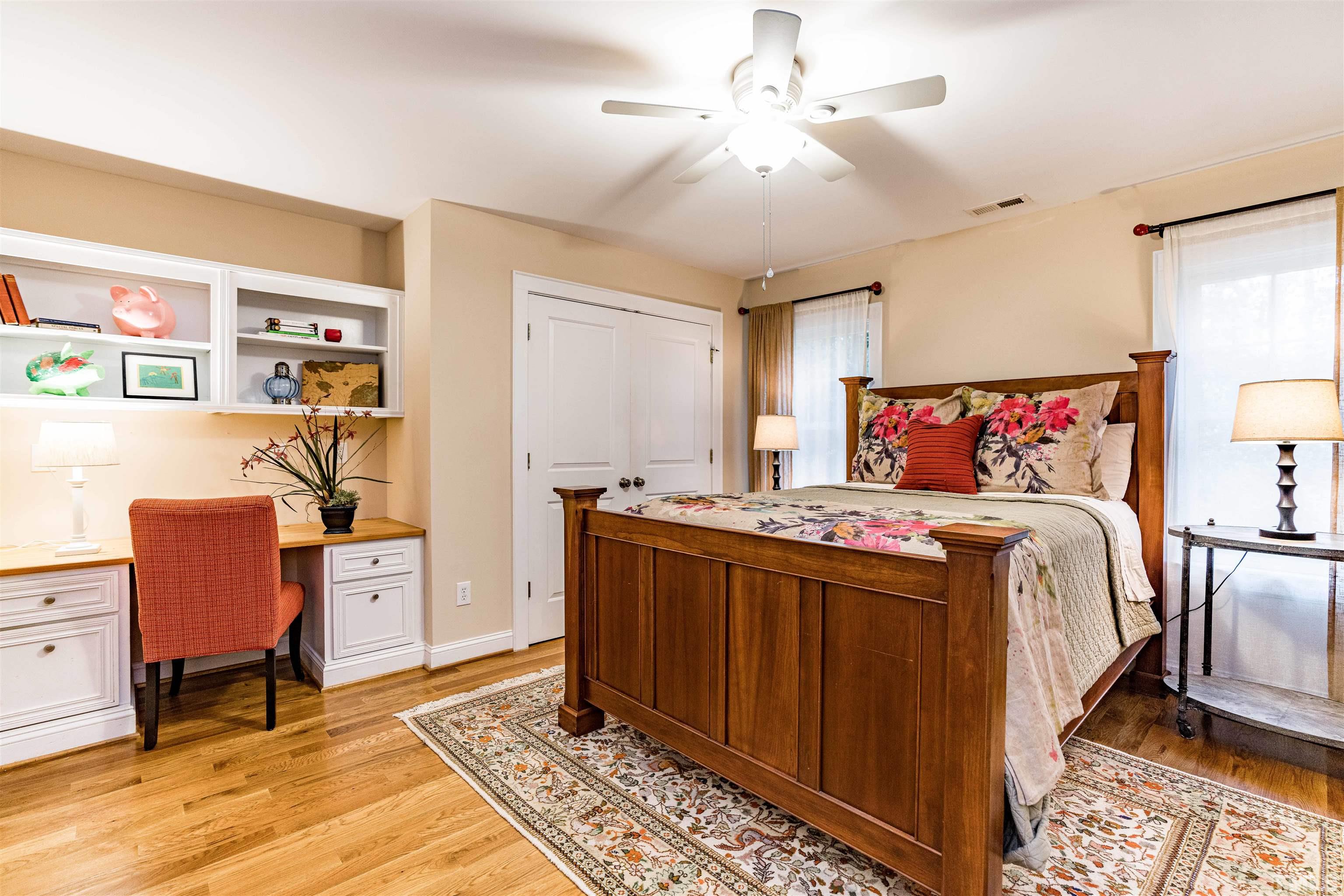 2706 Barmettler Street Raleigh, NC 27607 - Photo 35 of 43 a bedroom with a bed and a chandelier