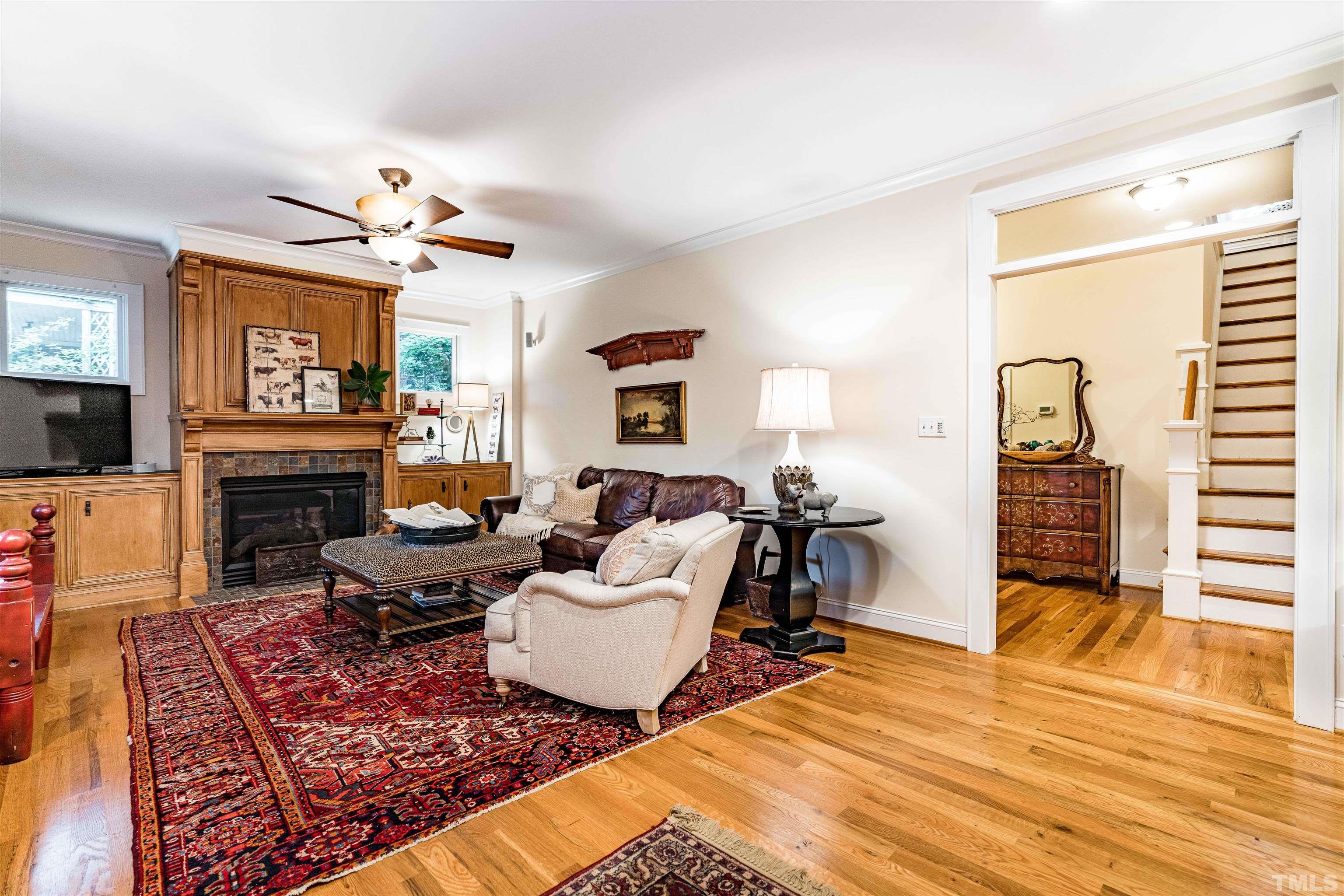 2706 Barmettler Street Raleigh, NC 27607 - Photo 7 of 43 a living room with furniture a fireplace and a flat screen tv
