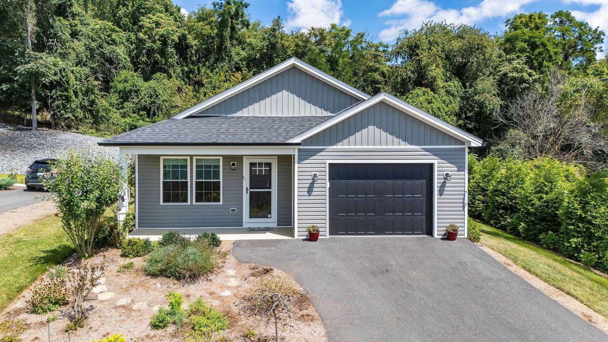 307 Kaolin Spring Lane Greenville, VA 24440 - Photo 2 of 7 a front view of a house with a yard and garage
