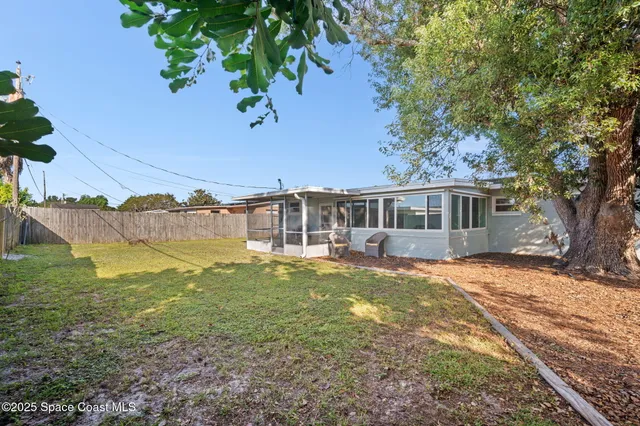 a backyard of a house with a garden and deck