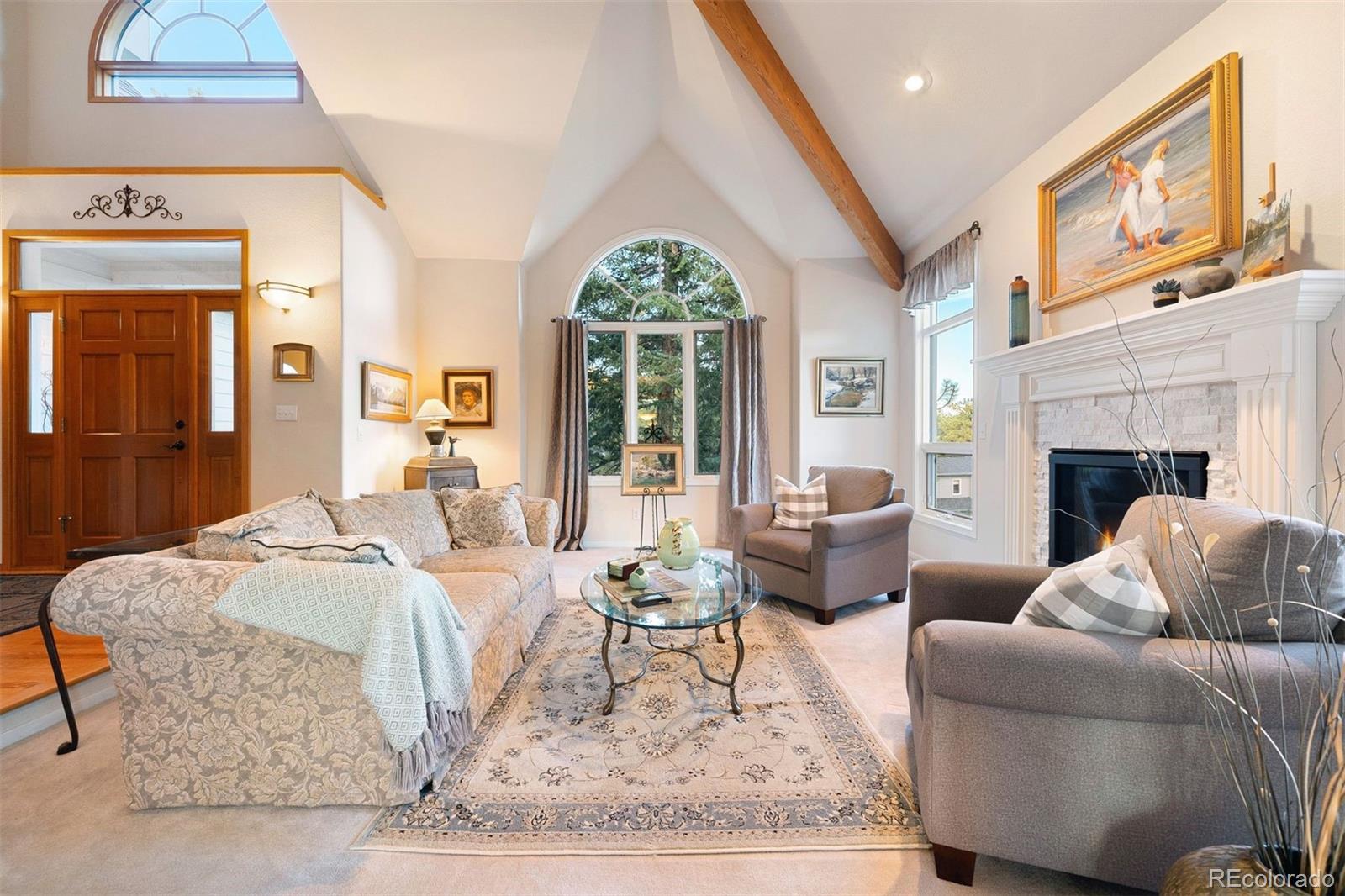 4275 Stonecliff Drive Evergreen, CO 80439 - Photo 11 of 48 a living room with furniture fireplace and a table