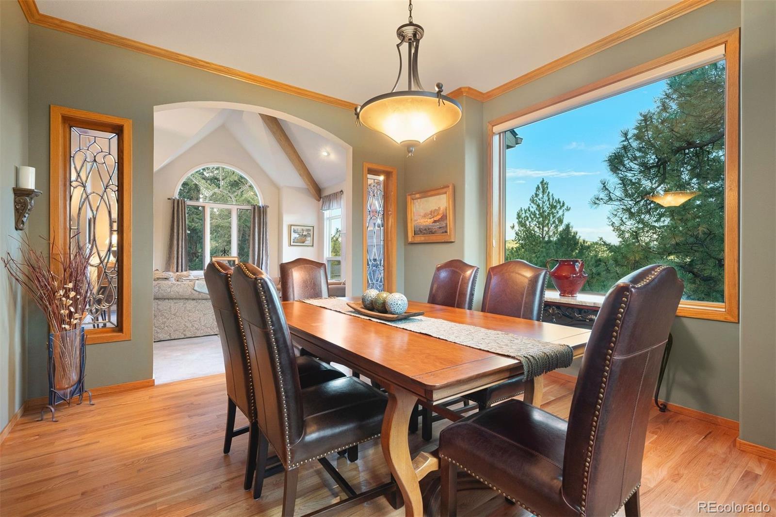 4275 Stonecliff Drive Evergreen, CO 80439 - Photo 13 of 48 a view of a dining room with furniture window and wooden floor
