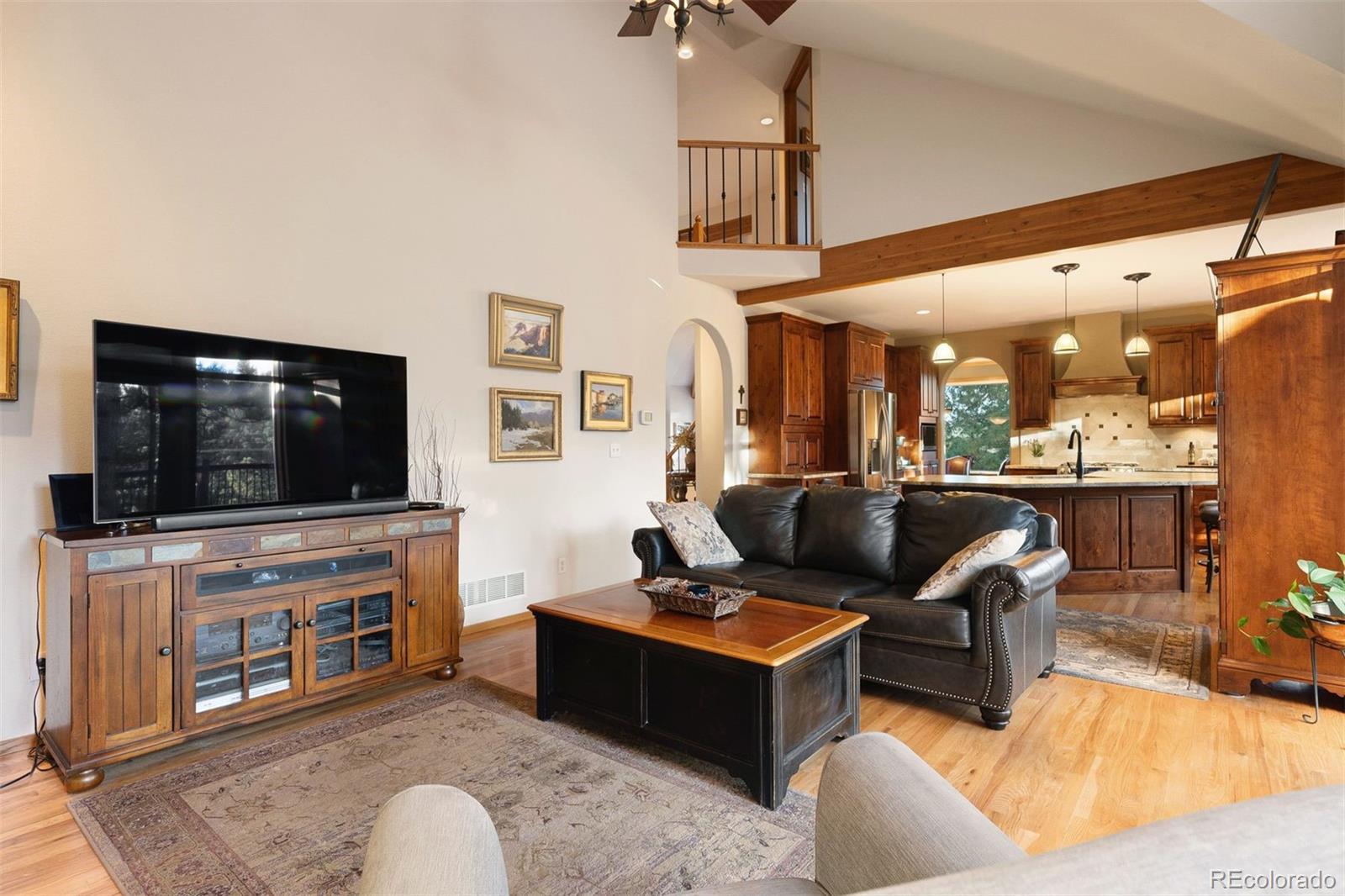 4275 Stonecliff Drive Evergreen, CO 80439 - Photo 15 of 48 a living room with furniture and a flat screen tv
