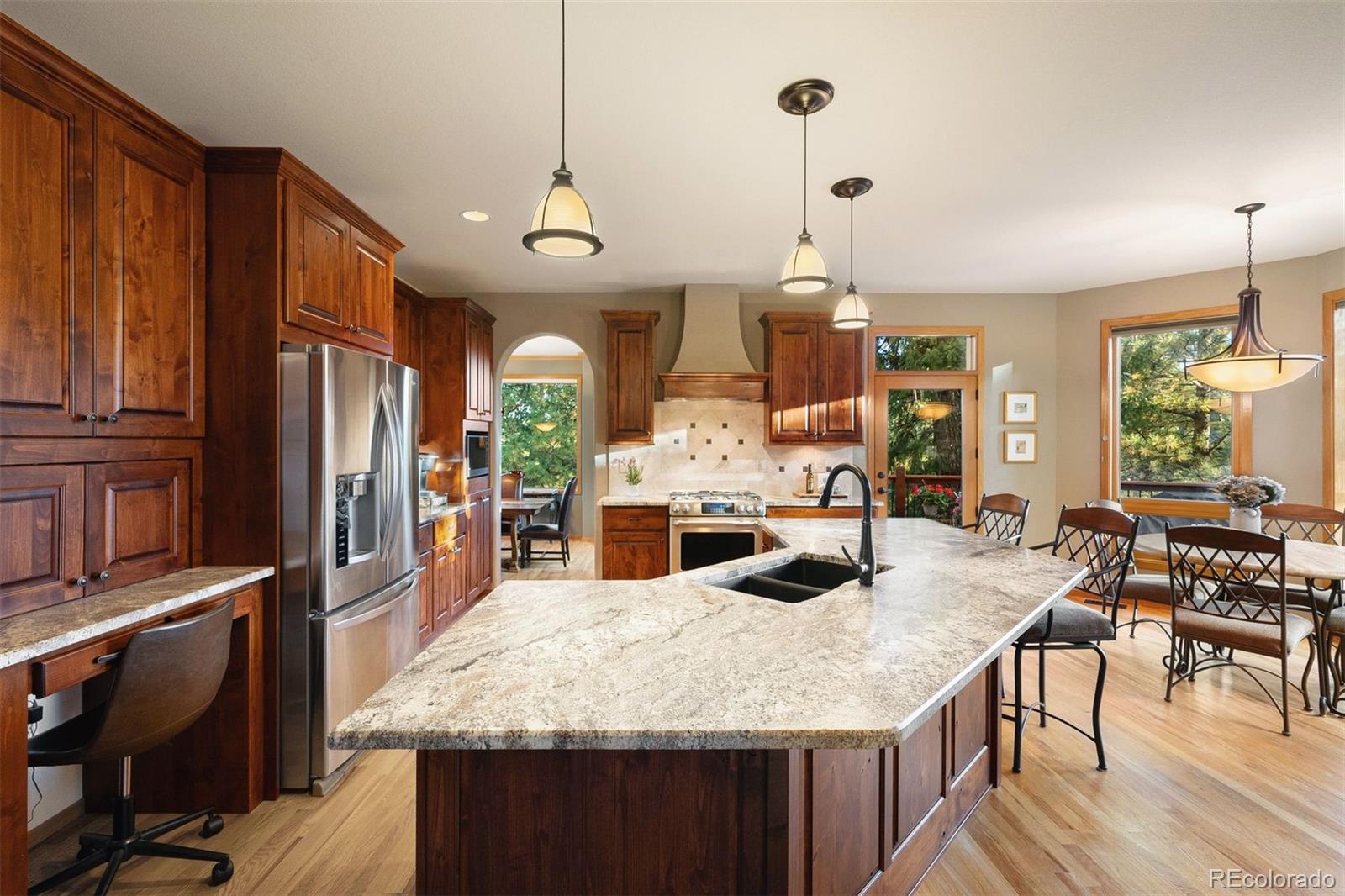 4275 Stonecliff Drive Evergreen, CO 80439 - Photo 16 of 48 a large kitchen with kitchen island a large island in it