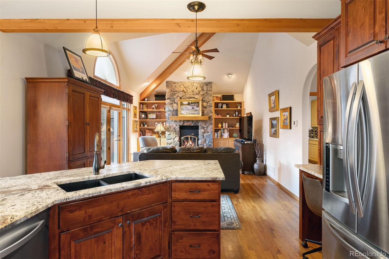 4275 Stonecliff Drive Evergreen, CO 80439 - Photo 20 of 48 a kitchen with stainless steel appliances granite countertop a refrigerator a stove and a sink