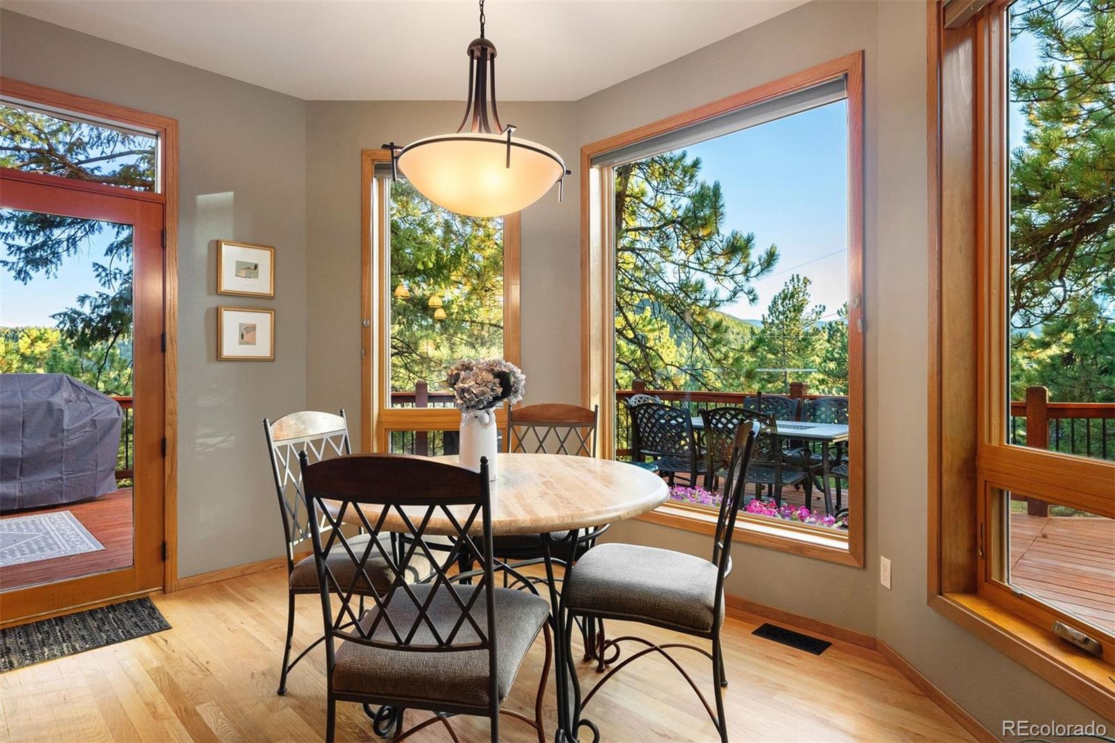 4275 Stonecliff Drive Evergreen, CO 80439 - Photo 21 of 48 a view of a dining room with furniture window and wooden floor