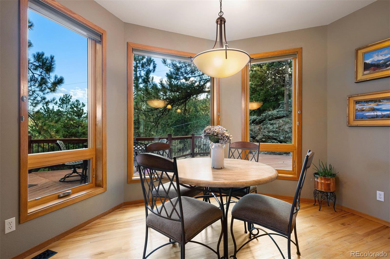 4275 Stonecliff Drive Evergreen, CO 80439 - Photo 22 of 48 a view of a dining room with furniture window and outside view