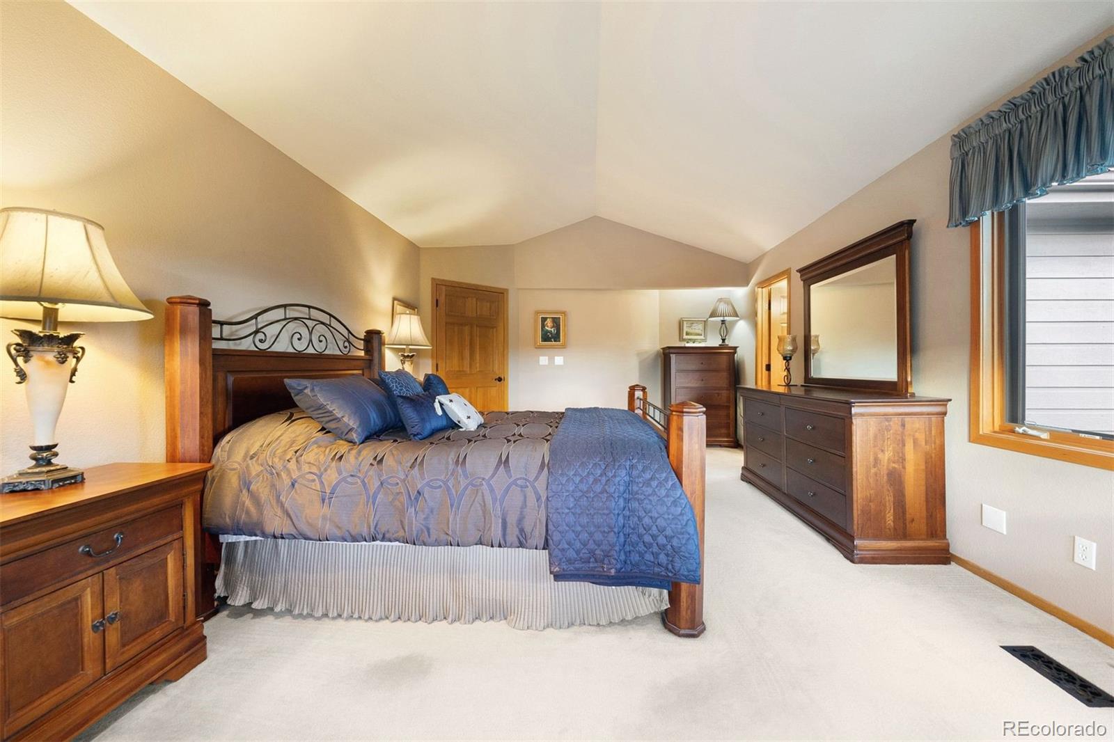 4275 Stonecliff Drive Evergreen, CO 80439 - Photo 27 of 48 a bedroom with a bed and large windows