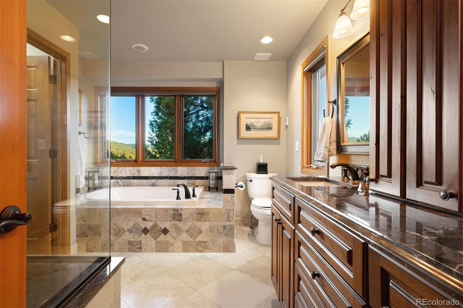 4275 Stonecliff Drive Evergreen, CO 80439 - Photo 28 of 48 a view of a kitchen with kitchen island a large window in it